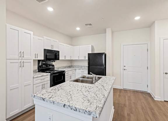 Peaks of Lexington Apartments Kitchen with Black Appliances, Granite Countertops and White Cabinetry