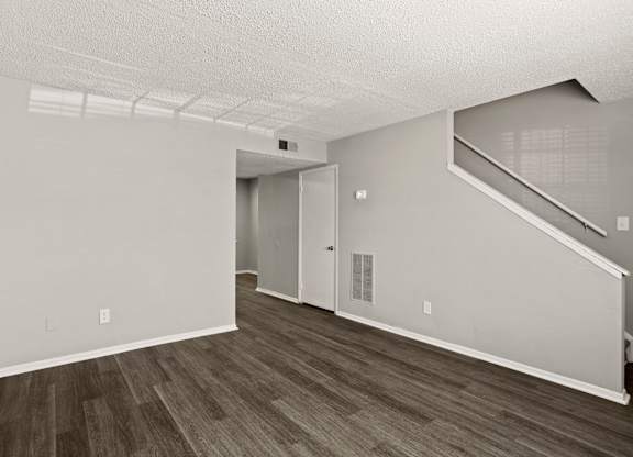 A room with a staircase and a door.