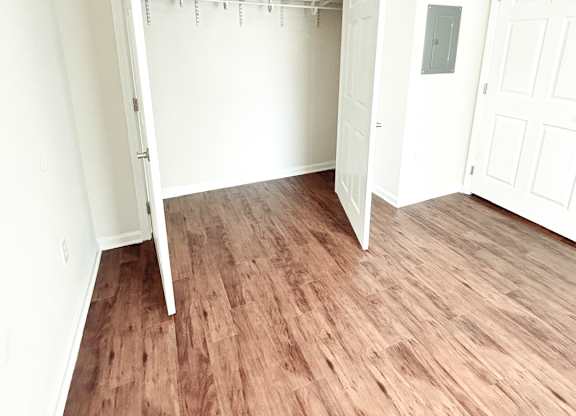 Brookside Gardens bedroom with wooden floors and closet