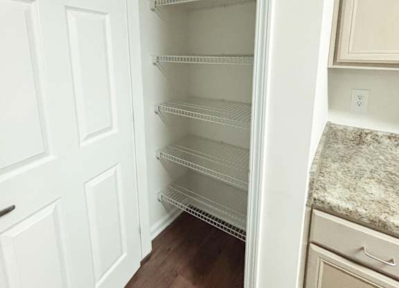 Empty white shelves in a kitchen.