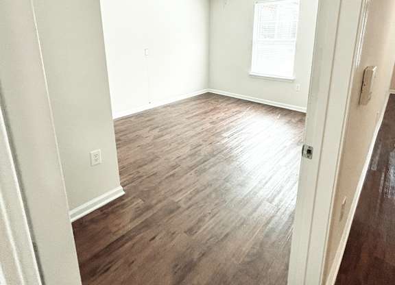 Brookside Gardens bedroom with a ceiling fan, a window and hardwood floors