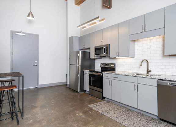 Converse Mill Lofts Kitchen with Stainless Steel Energy Efficient GE Appliances and Granite Countertops