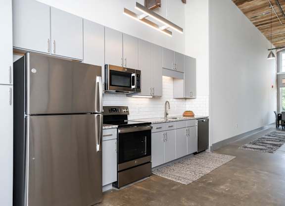 Converse Mill Lofts Kitchen with Stainless Steel Energy Efficient GE Appliances and Granite Countertops
