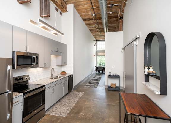 Kitchen in Converse Mill Lofts Apartments in Spartanburg SC with Stainless Steel Appliances and granite countertops