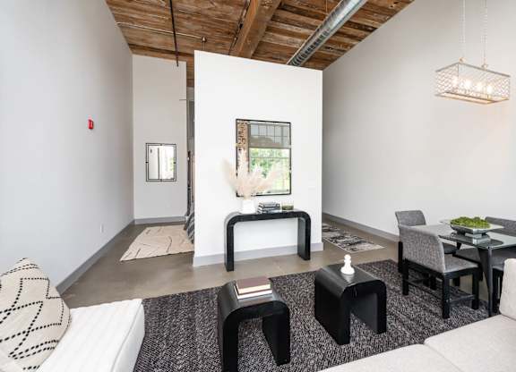 Converse Mill Lofts Luxury Apartments Model Unit Living Room with High Ceilings and Exposed Wood