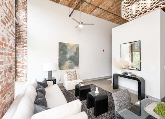 Converse Mill Lofts Luxury Apartments Model Unit Living Room with High Ceilings and Exposed Wood