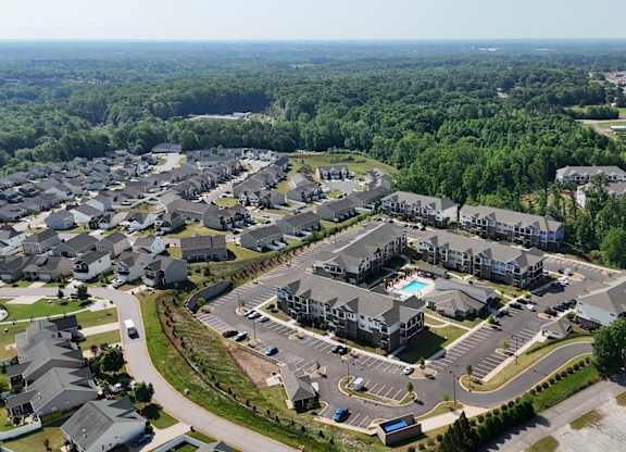 A bird's eye view of a residential complex with a swimming pool.