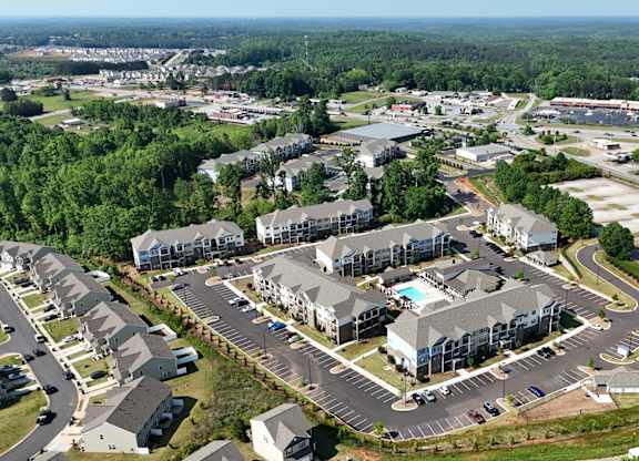A bird's eye view of a resort with a parking lot in the foreground.