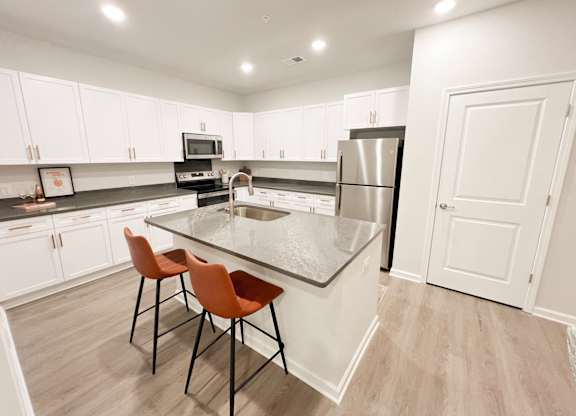 Pet-Friendly Luxury Apartments In Boiling Springs, SC - Grande At Geyser Falls - Kitchen with Island and Stainless Steel Appliances