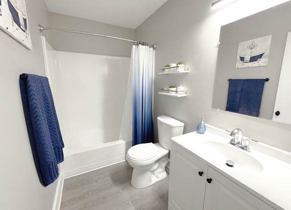 Reserve at Hillcrest model bathroom with a blue shower curtain and blue towel