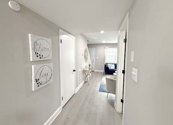 Reserve at Hillcrest furnished model unit downstairs hallway looking into living room