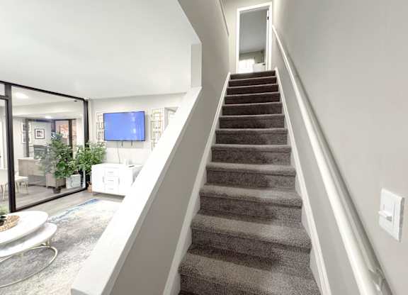 Reserve at Hillcrest Townhomes stairs of furnished model unit, connected to the leasing office