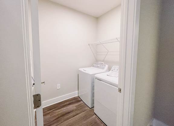 a washer and dryer in a small room in a room with a door
