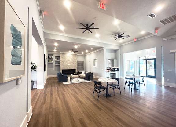 a large living room with a table and chairs and a fireplace