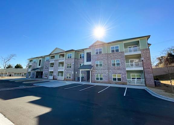 A sunny day at a multi-story apartment complex.