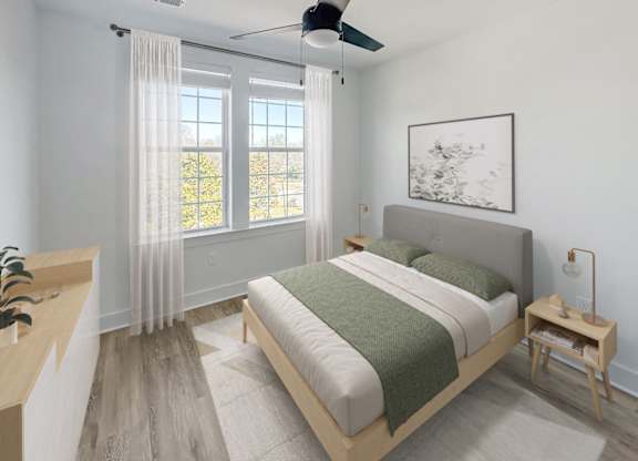 Gordon Street Lofts Bedroom with bed, rug, dresser and floor-to-ceiling curtains.