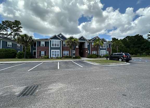 a parking lot in front of an apartment building