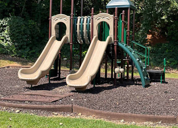 A playground with two slides and two towers.