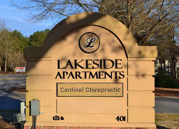 a sign for lakeside apartments on the side of a road
