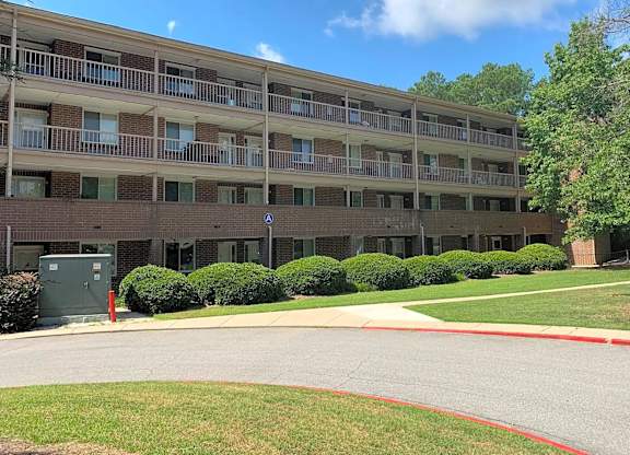 A large apartment complex with a red line painted on the road.