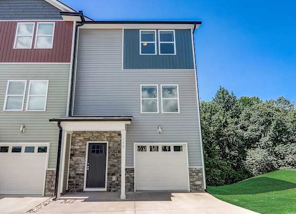 a house with two garage doors on the side of it