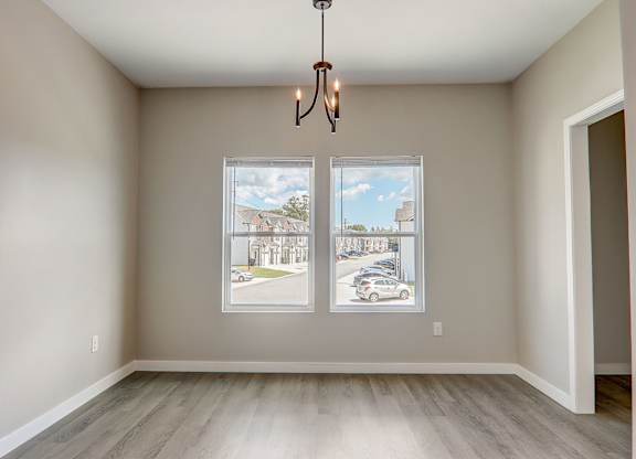 an empty living room with windows and a street view