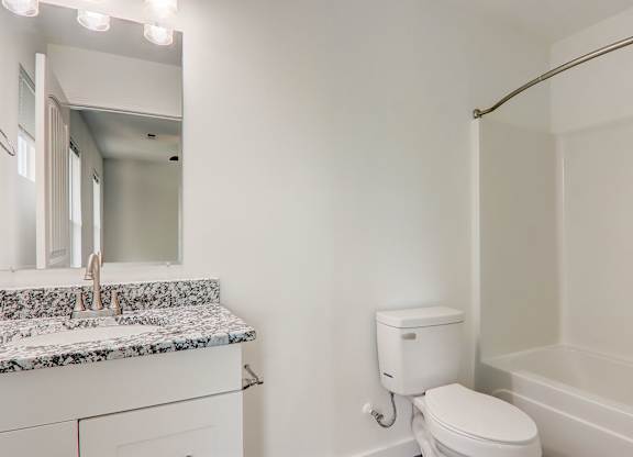 a bathroom with a toilet and a sink and a mirror