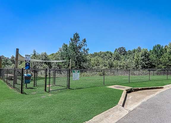 a view of a wire fence with trees in the background