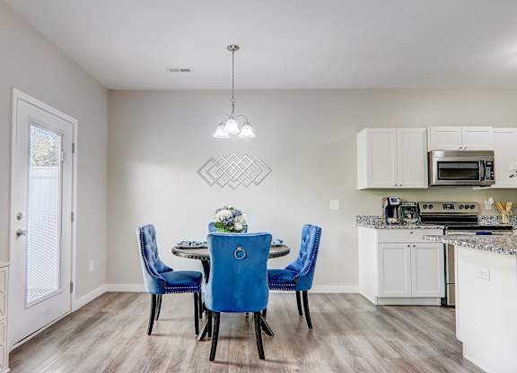 an open kitchen and dining room with a table and chairs
