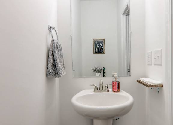 a small bathroom with a sink and a mirror