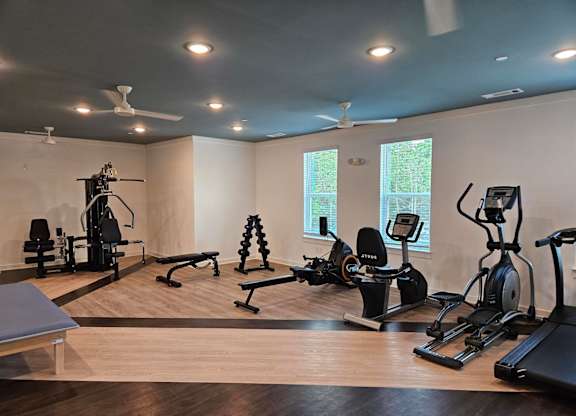 A spacious home gym with a variety of exercise equipment.