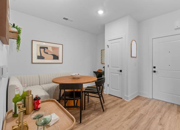 A dining area with a table and chairs.