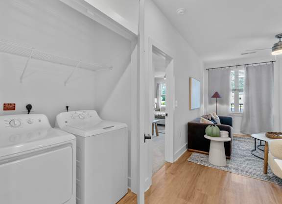 A white bathroom with a washer and dryer.