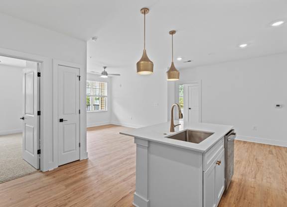 A kitchen with a sink and a counter.