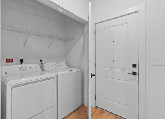 A white laundry room with a washer and dryer.