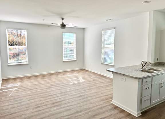 Ovata at Reedy Creek Kitchen & Living Room, with LVP hardwood-style flooring and a kitchen island