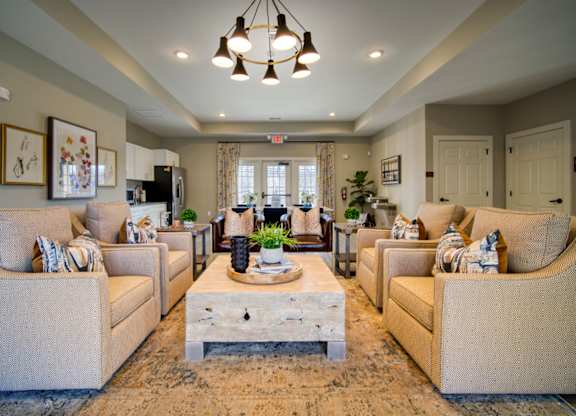 A living room with beige couches and a wooden coffee table.