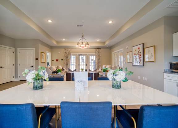 A dining room with a table set for six.