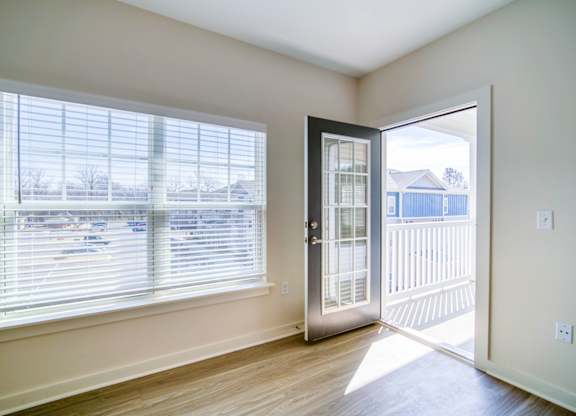 A room with a sliding glass door leading to a deck.
