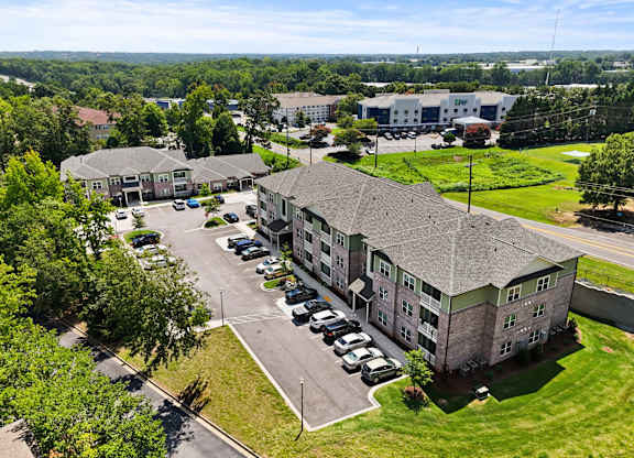 A large building with a parking lot in front of it.