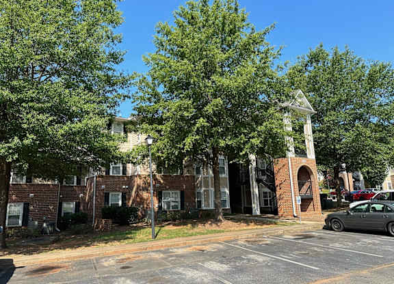 a parking lot in front of a brick building