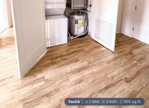 A small room with a white door open to a kitchen area.