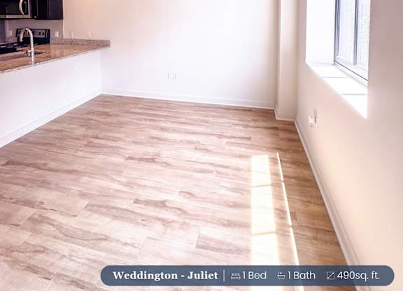 A room with wooden flooring and a ceiling fan.