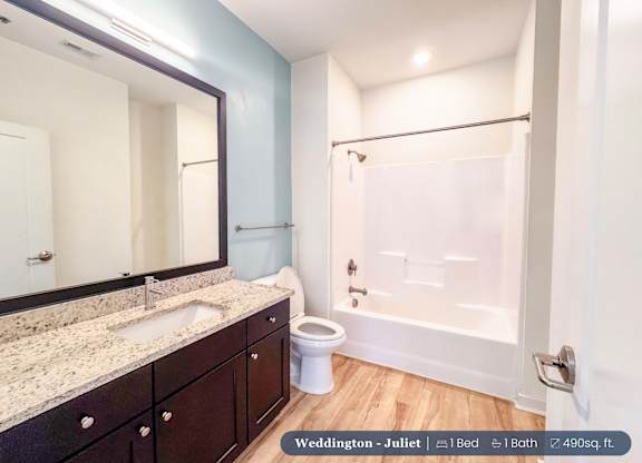 A bathroom with a sink, toilet, and bathtub.