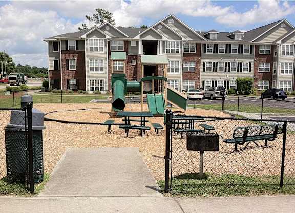 a playground in front of an apartment building