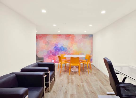 Meeting room with a colorful wallpaper and a table with chairs. at Midvale Court, Los Angeles