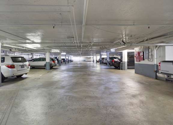 A parking garage with several cars parked. at The Hilgard, Los Angeles, 90024