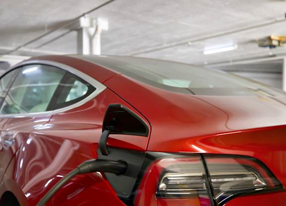 A red car is parked in a garage at The Hilgard, Los Angeles, 90024.