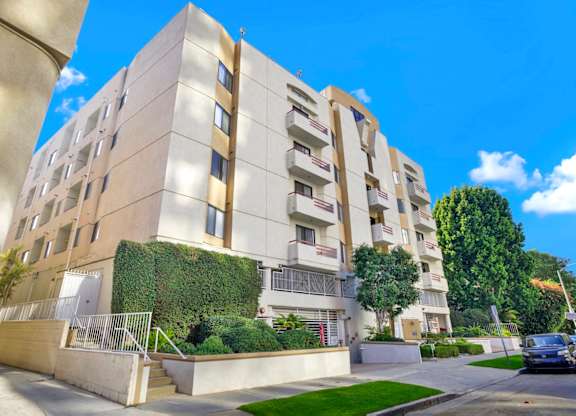 Exterior view of an apartment building with a clear blue sky above.