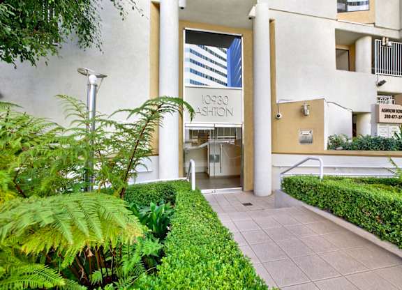 Exterior view of apartment building's building with a sign that says 10930 Ashton.
